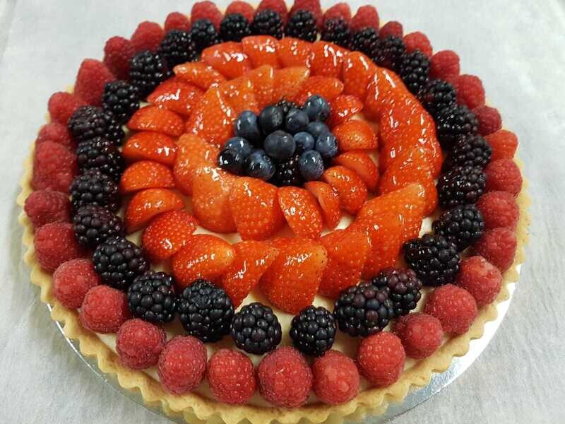 Berries tart covered with strawberries, raspberries, blackberries and blueberries