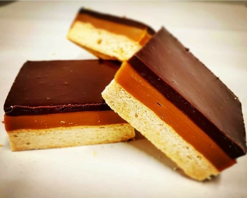 Millionaire shortcake slices showing shortbread, caramel and chocolate